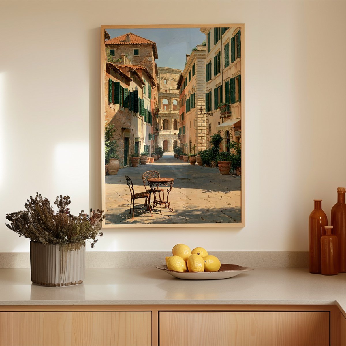 The framed print above a sideboard styled with lemons on a dish, dried lavender and amber glass bottles.