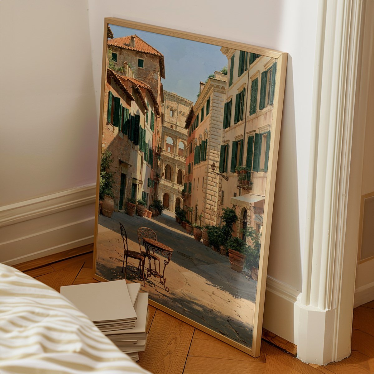 The framed print leaning against a pale wall on a wooden floor, next to a stack of boards.